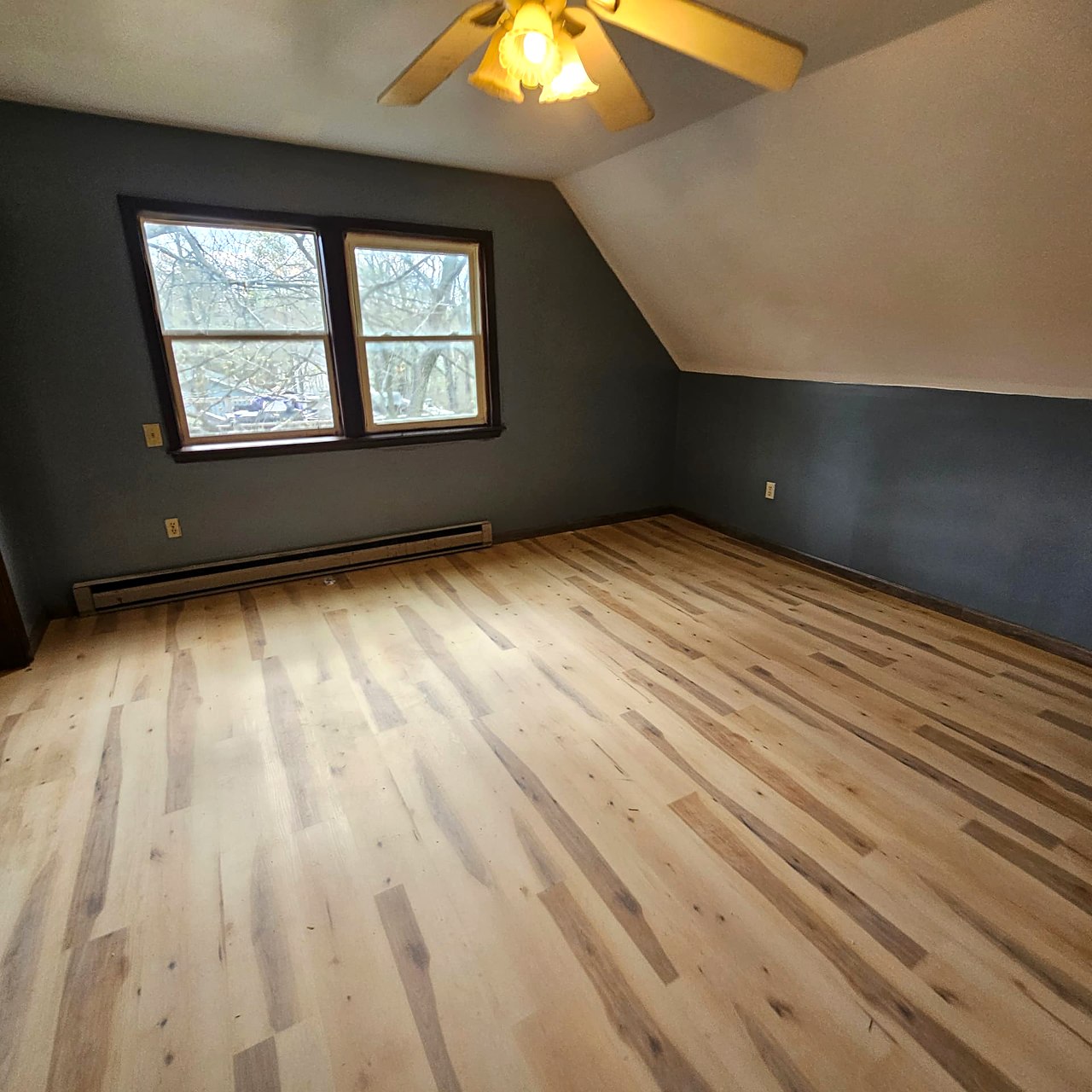 Light wood-look plank flooring in an upstairs bedroom